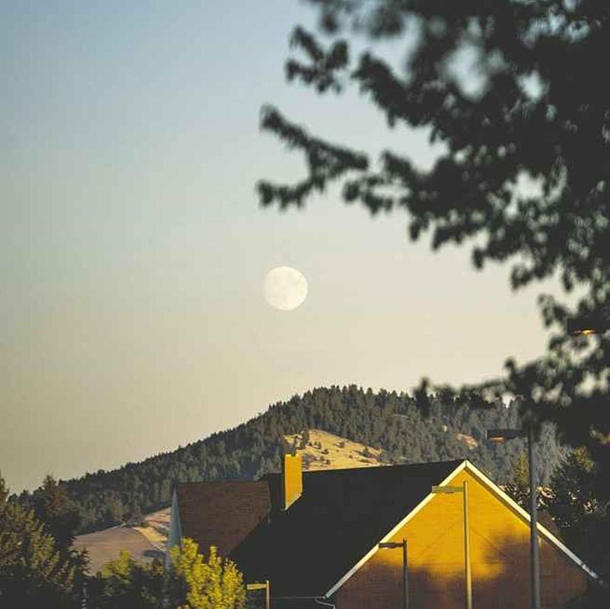 The moon rises over homes near the University of Idaho in Moscow.