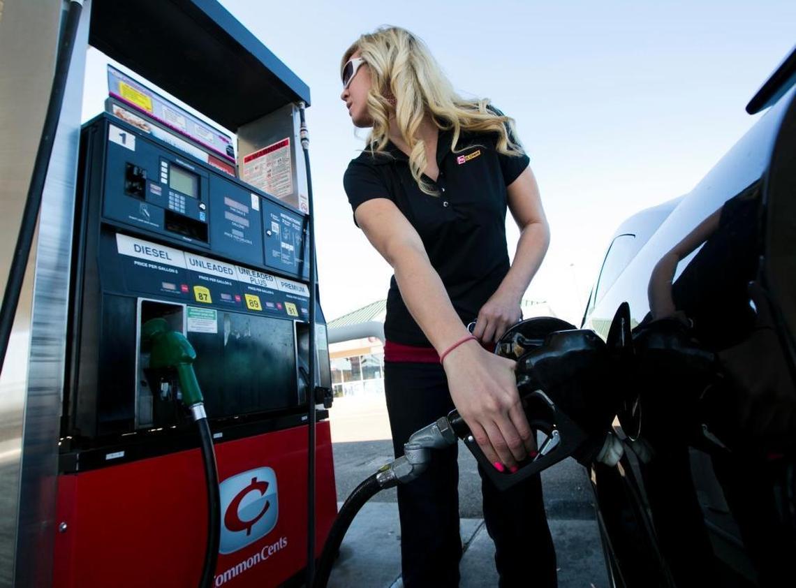 Caitlin Dill of Boise visits the gas pump to fill up her car in 2013 at a Boise filling station.