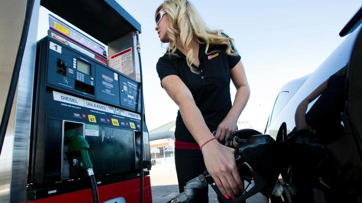 Caitlin Dill of Boise visits the gas pump to fill up her car Wednesday Oct.23, 2013 at a South Boise filling station.