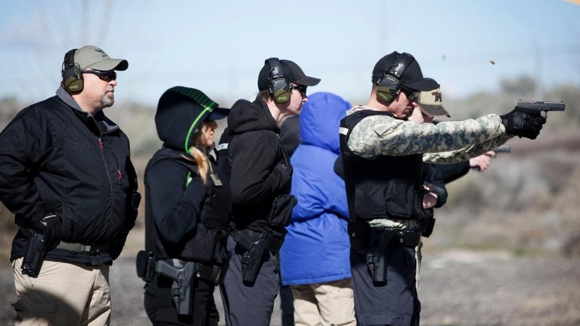 Twin Falls Police Department Sgt. Brent Wright, left, watches cadet Andrew Woolsey, right, at a two-shot reload drill at the Twin Falls Police Department gun range on March 17.