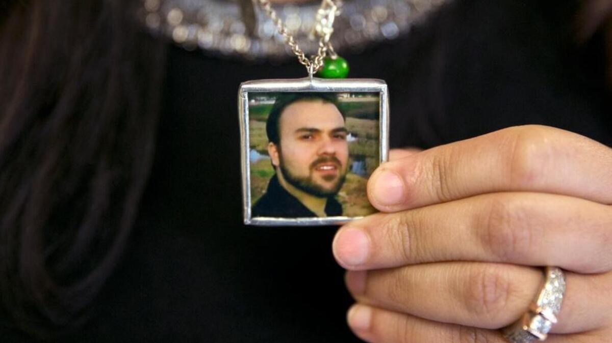 Naghmeh Abedini, holds a necklace with a photograph of her husband, Saeed Abedini, on Capitol Hill in June during a House Foreign Affairs Committee hearing with four people whose family members were being held in Iran.