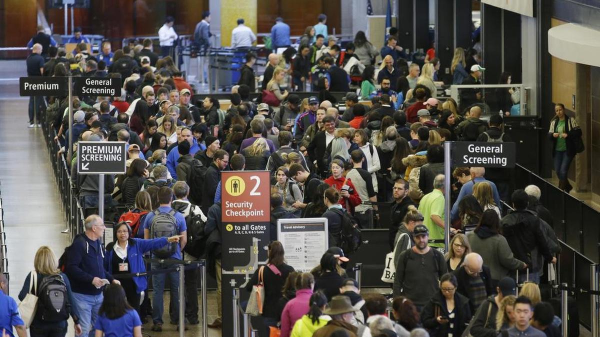 Travelers wait in line for security screening at Seattle-Tacoma International Airport in Seattle.