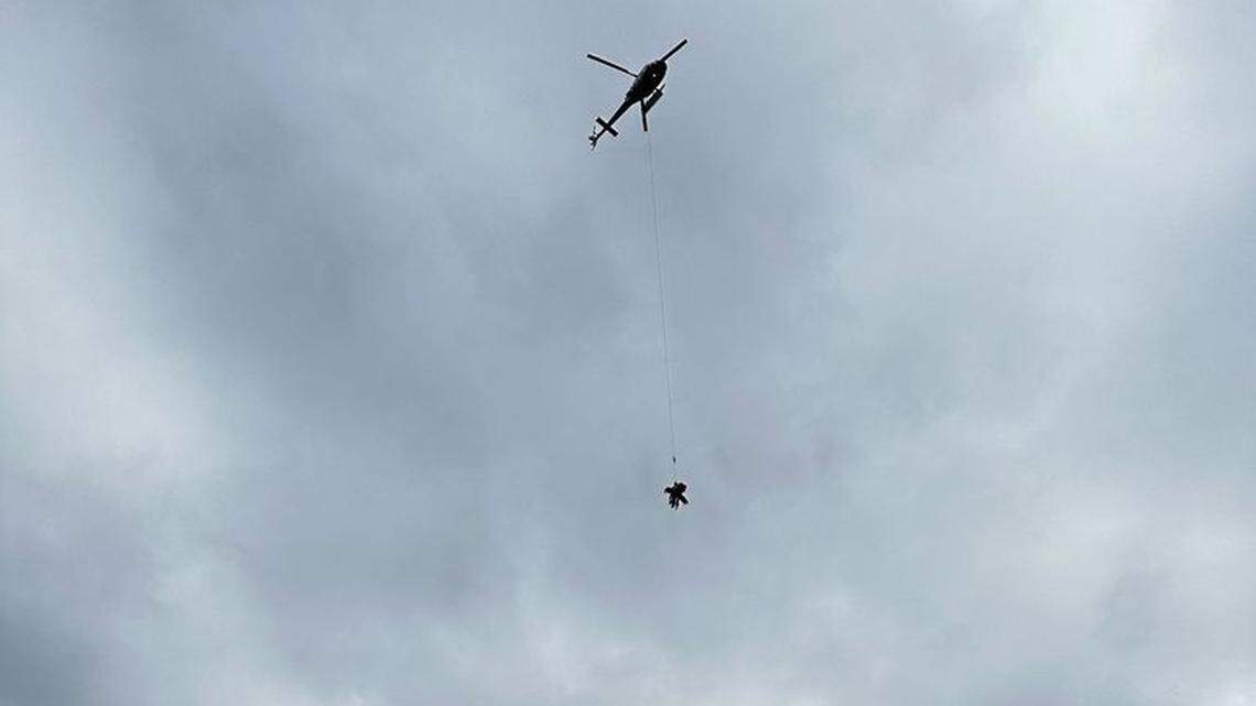 A young paraglider was rescued from an icy mountain after he tried flying from the summit and crashed back down onto the steep slope.