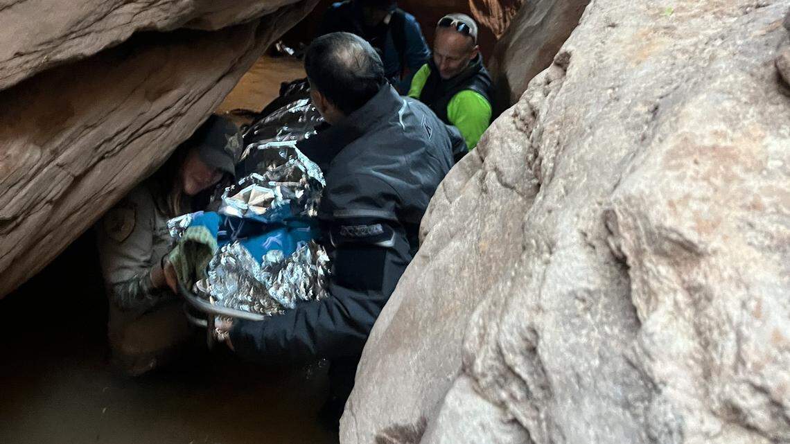 Rescuers carried a hiker with a broken leg through freezing water and rough terrain in a Utah canyon on Thanksgiving, photos show.