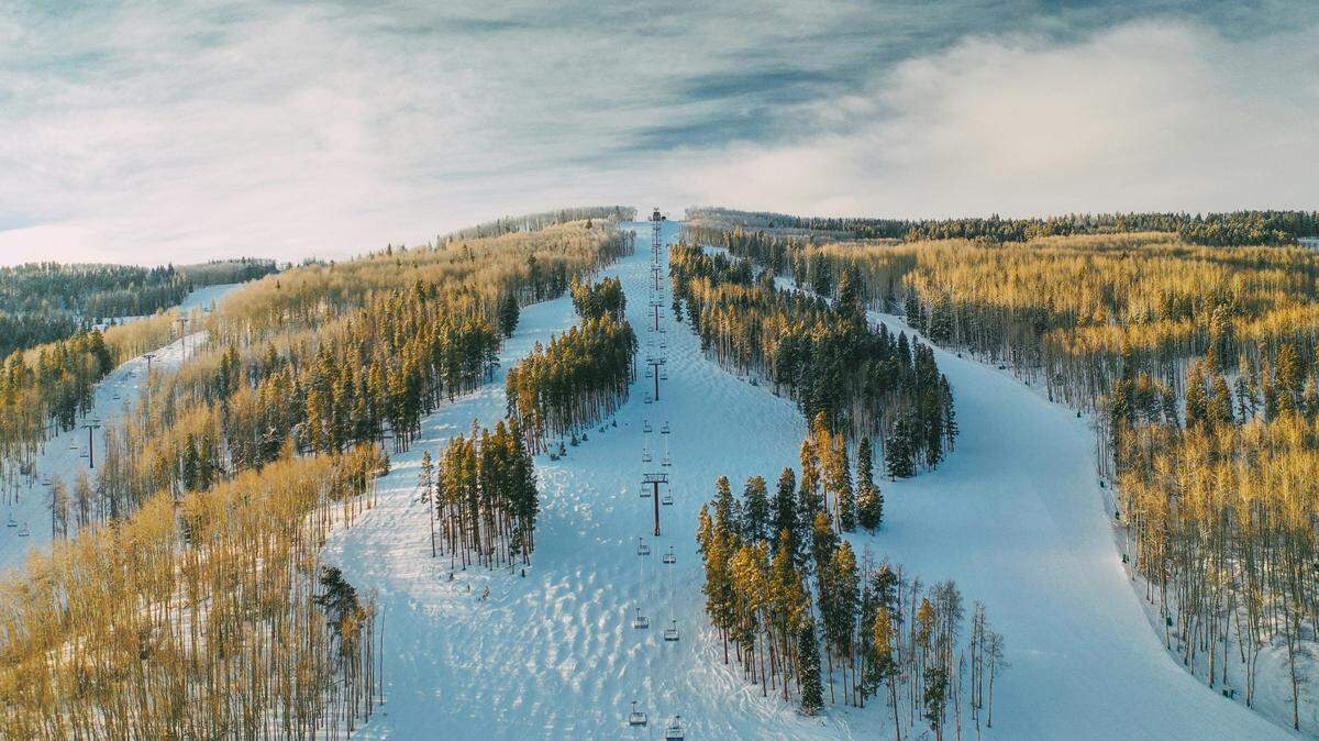 A snowboarder fell nearly 50 feet from a chairlift at a Colorado ski resort, officials said.