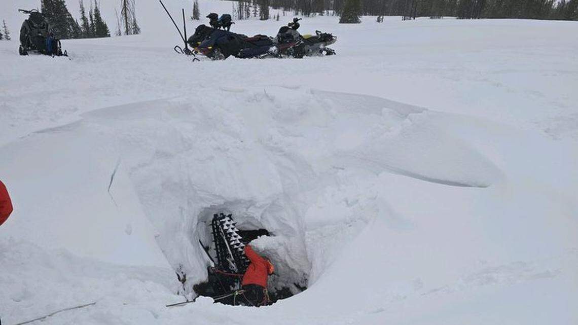A snowmobiler accidentally drove into a vertical mine shaft and dangled 20 feet above the bottom, Utah rescuers said.