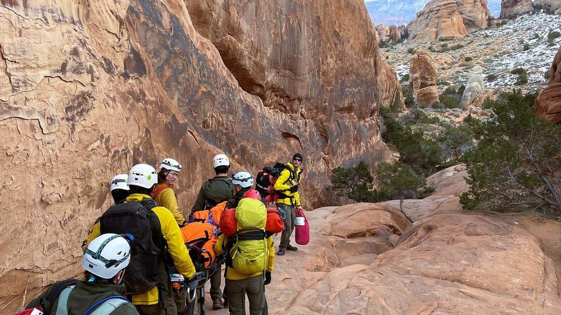 Rescuers carried an injured hiker more than a mile through the treacherous backcountry after she fell down a steep rock wall in Arches National Park.