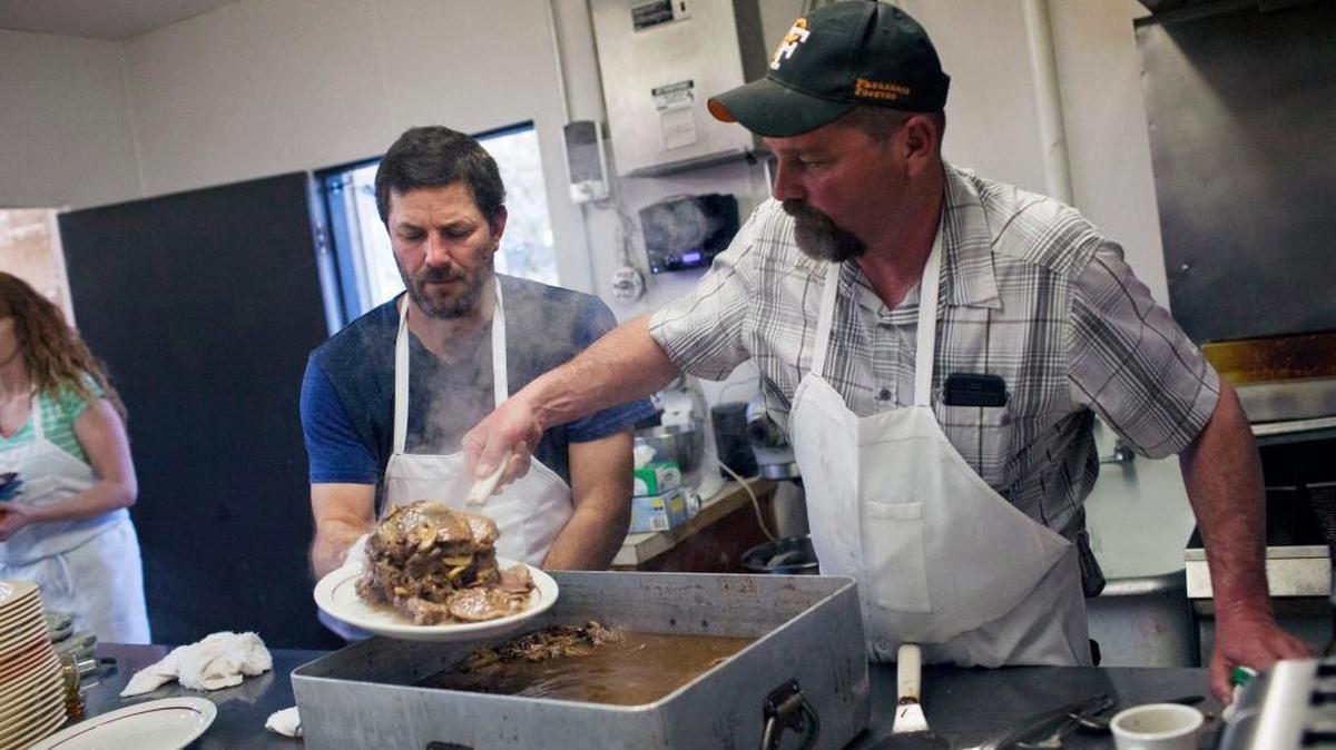 Joe Carter and Brad Schell, right, prepare lamb at the 58th Annual Basque Dinner Festival at the Elks Lodge in Rupert in March.