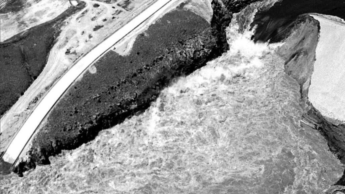 The chasm in the Teton Dam continued to widen as the pent-up water eroded the earthen structure. The 307-foot dam had been declared breached at 11:57 a.m. on June 5, 1976. This photo was taken a little after 1 p.m.