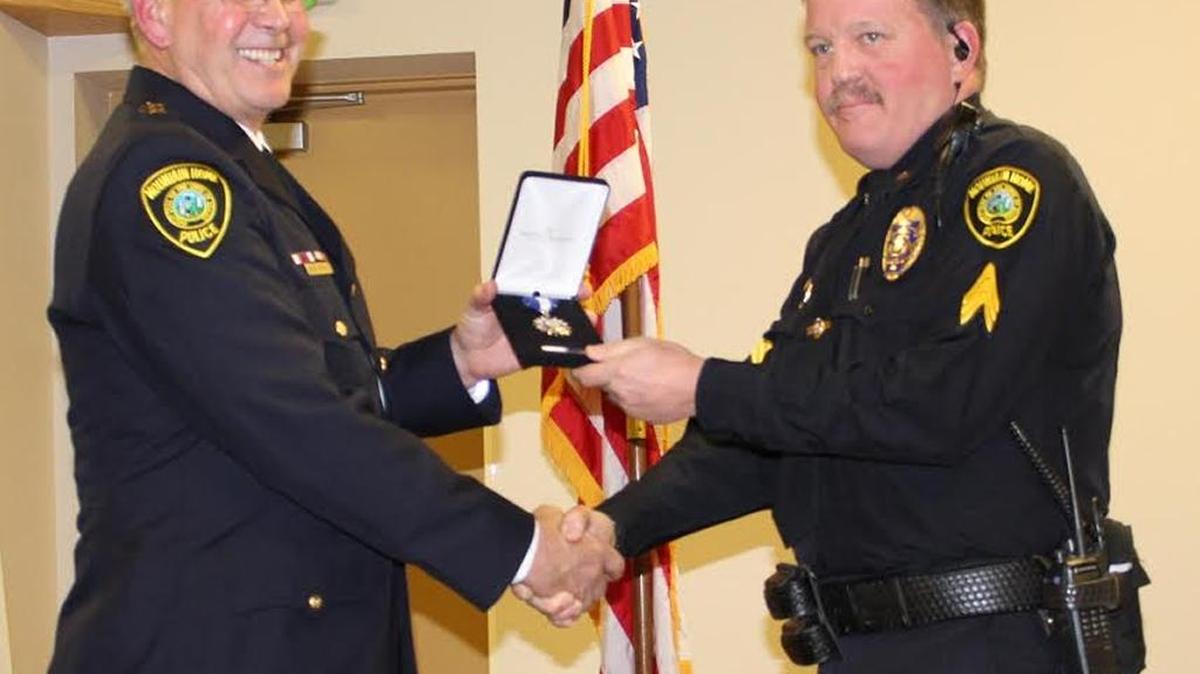 Mountain Home Police Sgt. Russell Griggs, right, receives the Medal of Valor from Police Chief Nick Schilz Jan. 9.