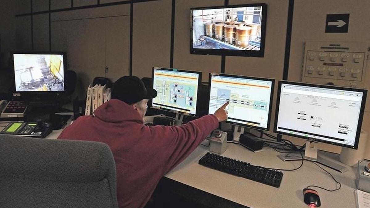 Dennis Haskett, an operation technician for The Advance Mixed Waste Treatment Project, explains how the processing of waste going through the facility can be monitored step by step with the use of multiple cameras and a computer program that tracks the progress.