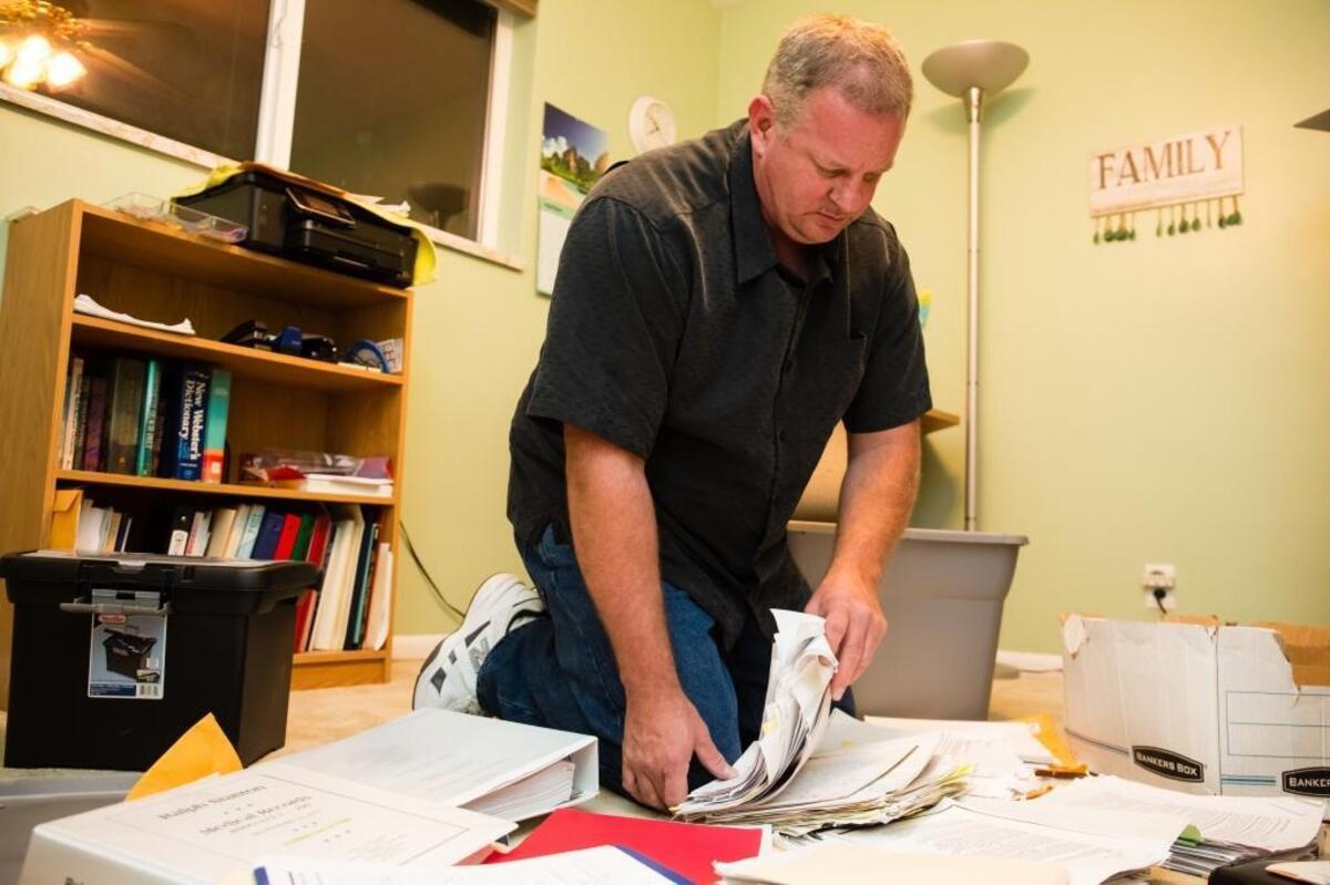 In November 2015, at his home in Idaho Falls, Ralph Stanton lays out some of his medical paperwork and evidence of his contamination at the Idaho National Laboratory.