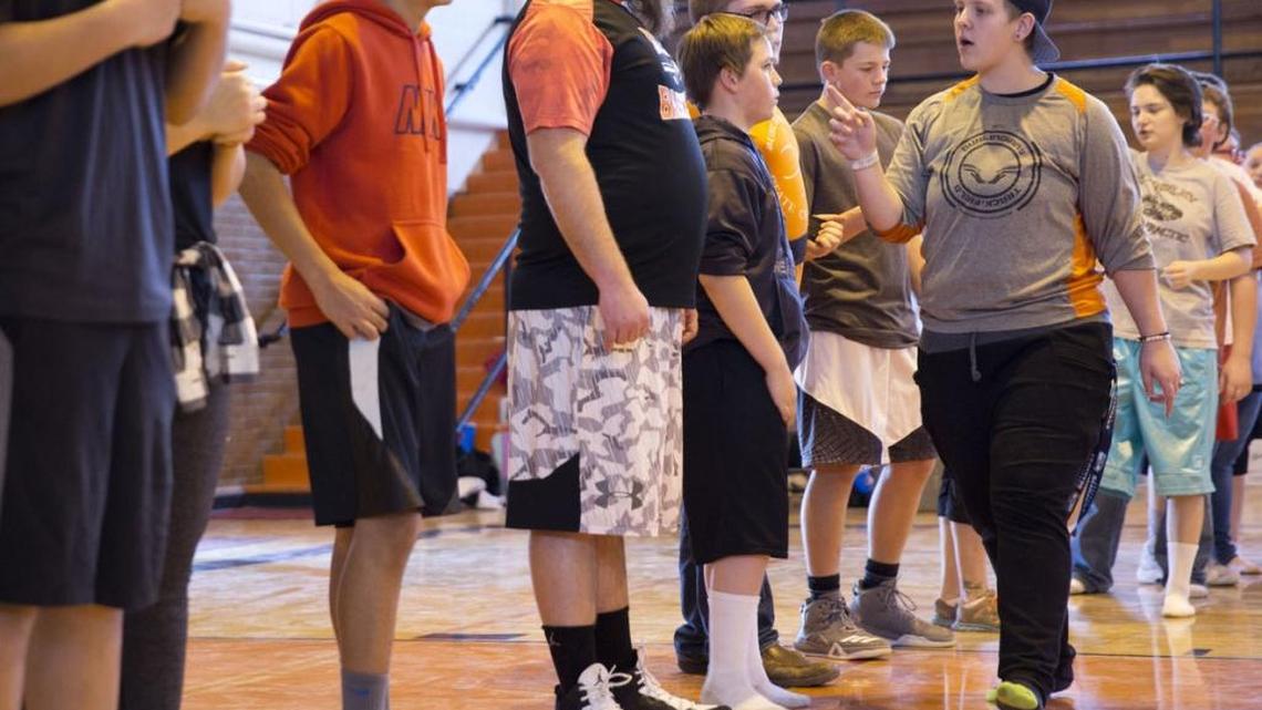 Former foster child Baylee Brown, 17, divides players into teams during a dodgeball tournament she organized for her senior project March 4 at the 7th Street Gym in Buhl. Tournament admission was a new hygiene product to be donated to a foster child.
