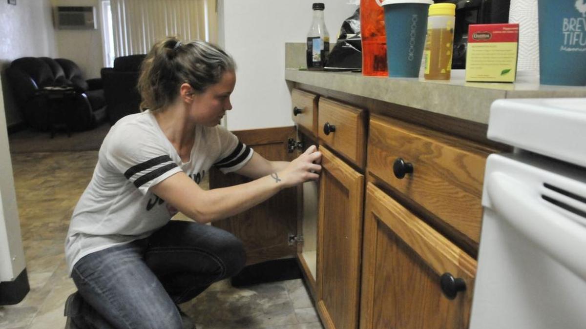 Amy Allred puts clean dishes away on Sept. 22 at her Filer home. Allred is creating a new life for herself after leaving a relationship riddled with domestic violence.