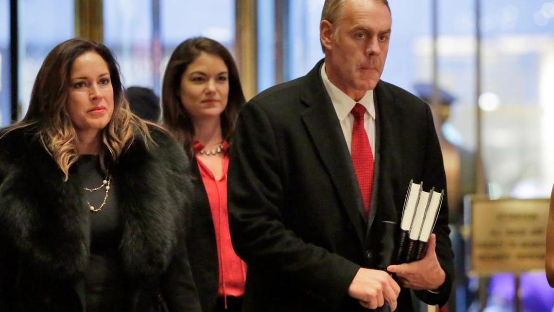 Rep. Ryan Zinke, right, R-Mont., arrives Monday in Trump Tower, in New York.