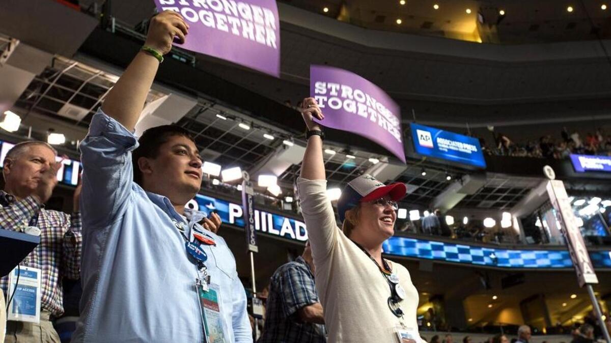Idaho Clinton delegates Jesse Maldonado, left, and Caitlin Lister show their support for Hillary Clinton at the Wells Fargo Center in Philadelphia.