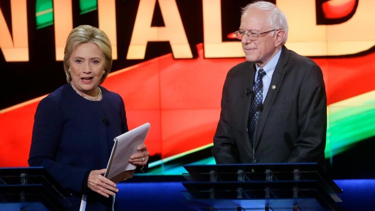 Democratic presidential candidates Hillary Clinton and Bernie Sanders end their March 6 debate in Flint, Mich.