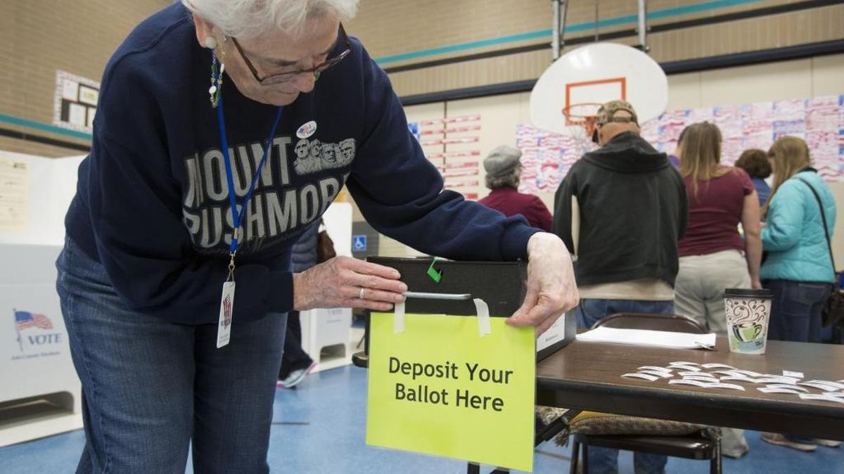 MaryLou Cox puts the final touches on a ballot box at Chief Joseph School of the Arts in Meridian at the start of the Nov. 4, 2014 election.