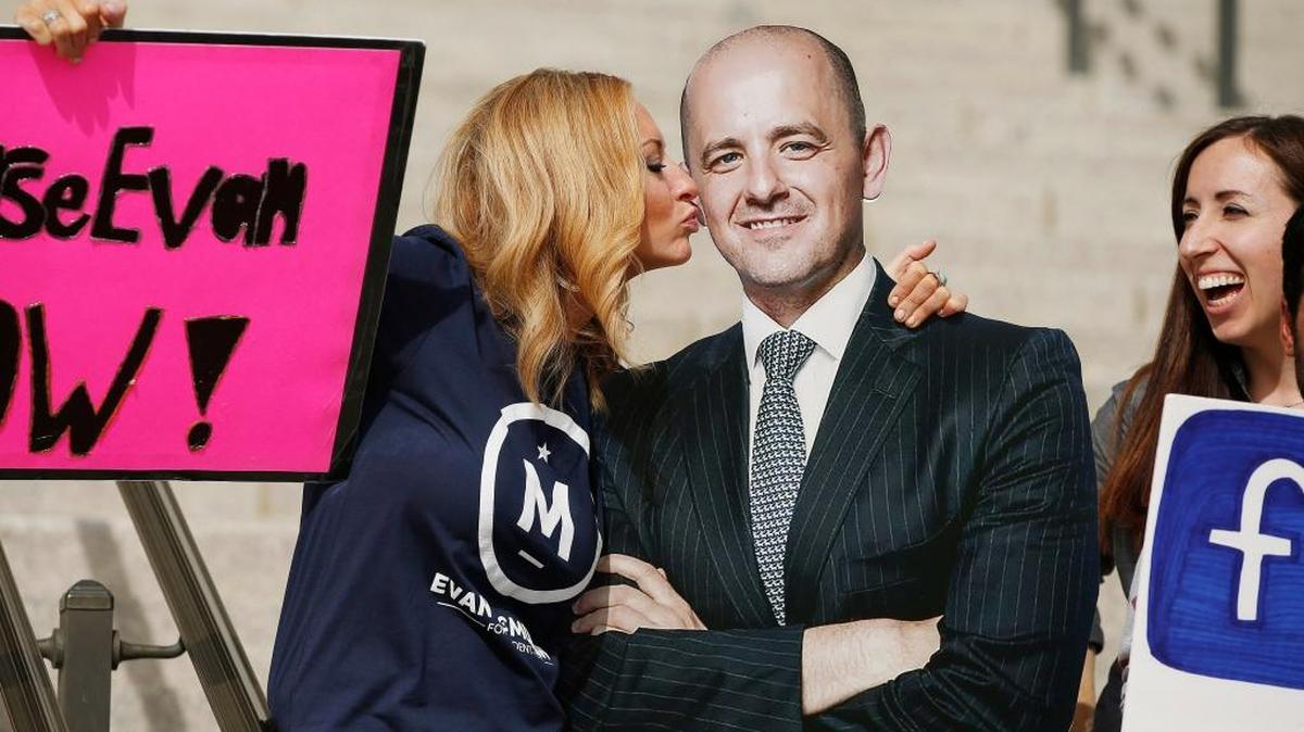 Brynnley Pyne pretends to kiss a cardboard cutout of Evan McMullin as McMullin supporters rally at the Utah State Capitol in Salt Lake City Oct. 13