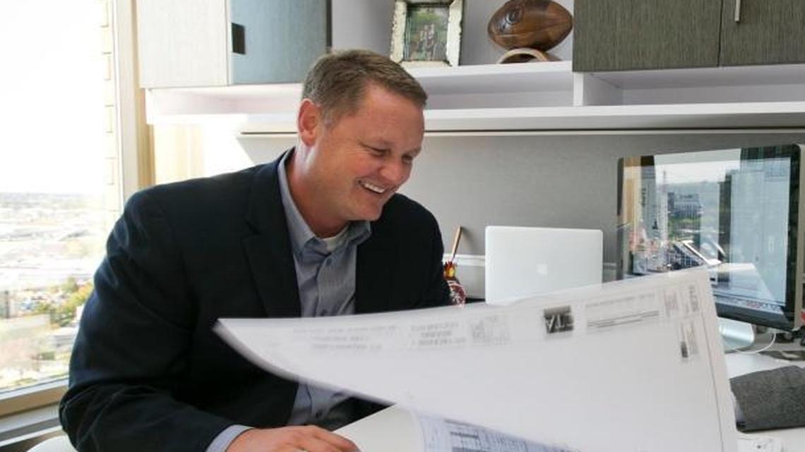 Tommy Ahlquist and his father, Tom Ahlquist, go over plans on a Gardner Co. project in October 2013 at their offices in Downtown Boise.