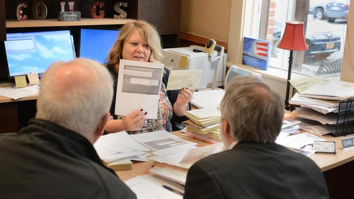 Asotin County Auditor Darla McKay shows vote ballots to County Commissoner Brian Shinn and Prosecutor Ben Nichols that have signatures that sometimes don't match signatures on record, potentially invalidating the vote.