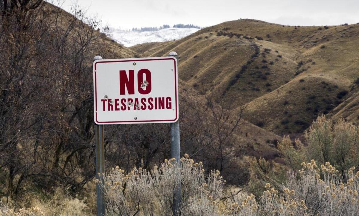 “No trespassing” signs can be found along many roads skirting open range in the Boise Foothills. This one attracted target shooters. Lawmakers are debating the most sizeable overhaul of Idaho trespassing law in years.
