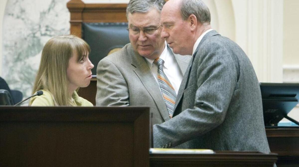 At center, House Speaker Scott Bedke, R-Oakley, confers Monday with Majority Leader Mike Moyle, R-Star, as the House works through remaining items with an eye toward adjournment on Tuesday. House Chief Clerk Carrie Maulin is at left.