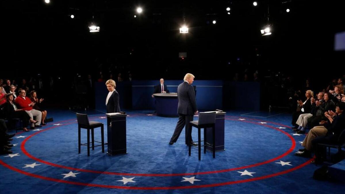 Hillary Clinton, left, and Donald Trump arrive for the second presidential debate in St. Louis Sunday.