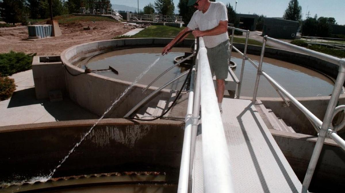 An employee cleans algae off a primary clarifier at an old waste water treatment plant in Meridian.