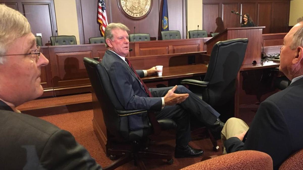 Gov. Butch Otter, center, just before he spoke to reporters Thursday.