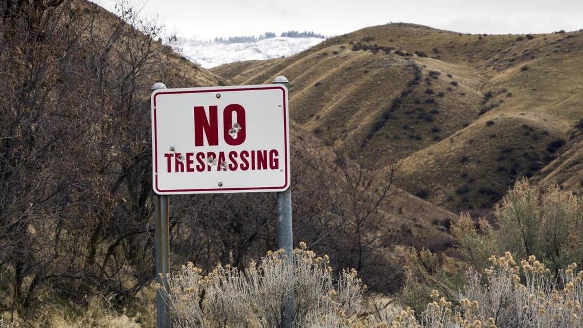 “No trespassing” signs can be found along many roads skirting open range in the Boise Foothills. This one attracted target shooters. Lawmakers are debating the most sizeable overhaul of Idaho trespassing law in years.