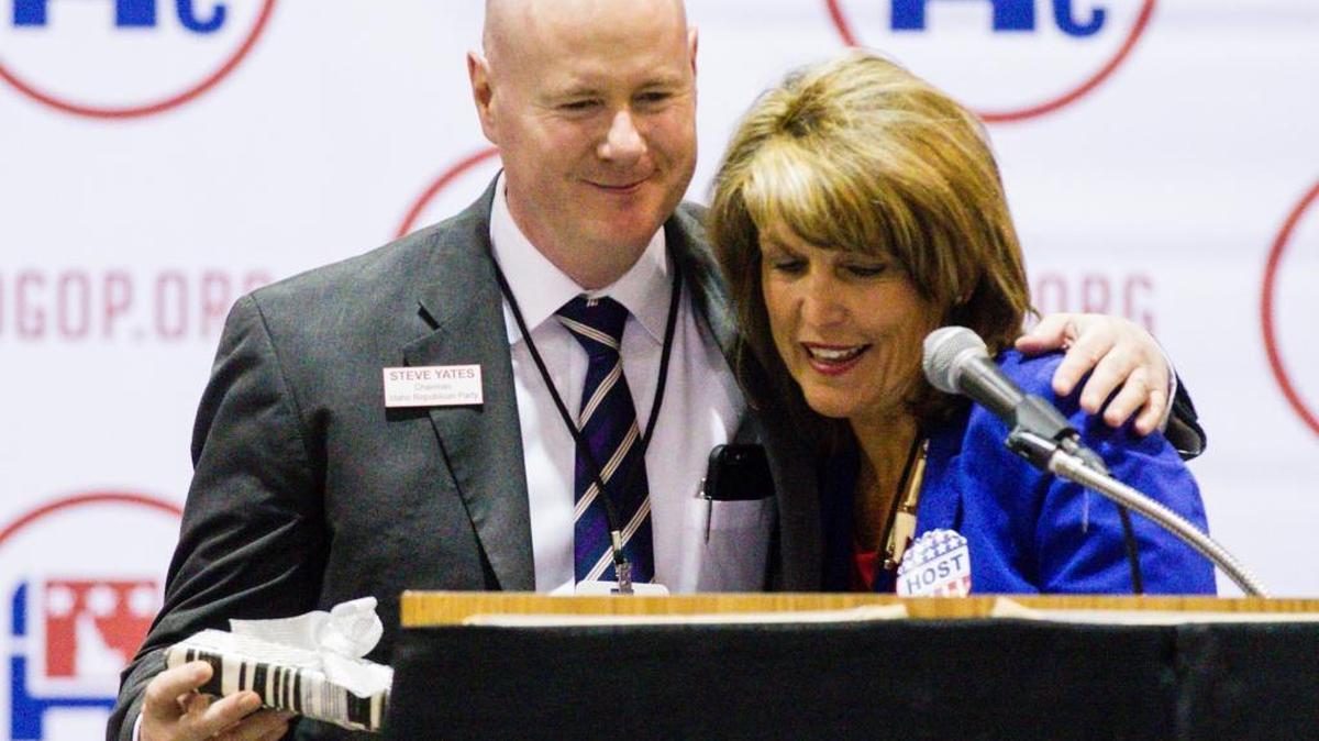 Idaho GOP Chairman Steve Yates accepts a gift from convention vice-chair Melinda Smyser after winning re-election June 4 at the Idaho GOP Convention in Nampa.