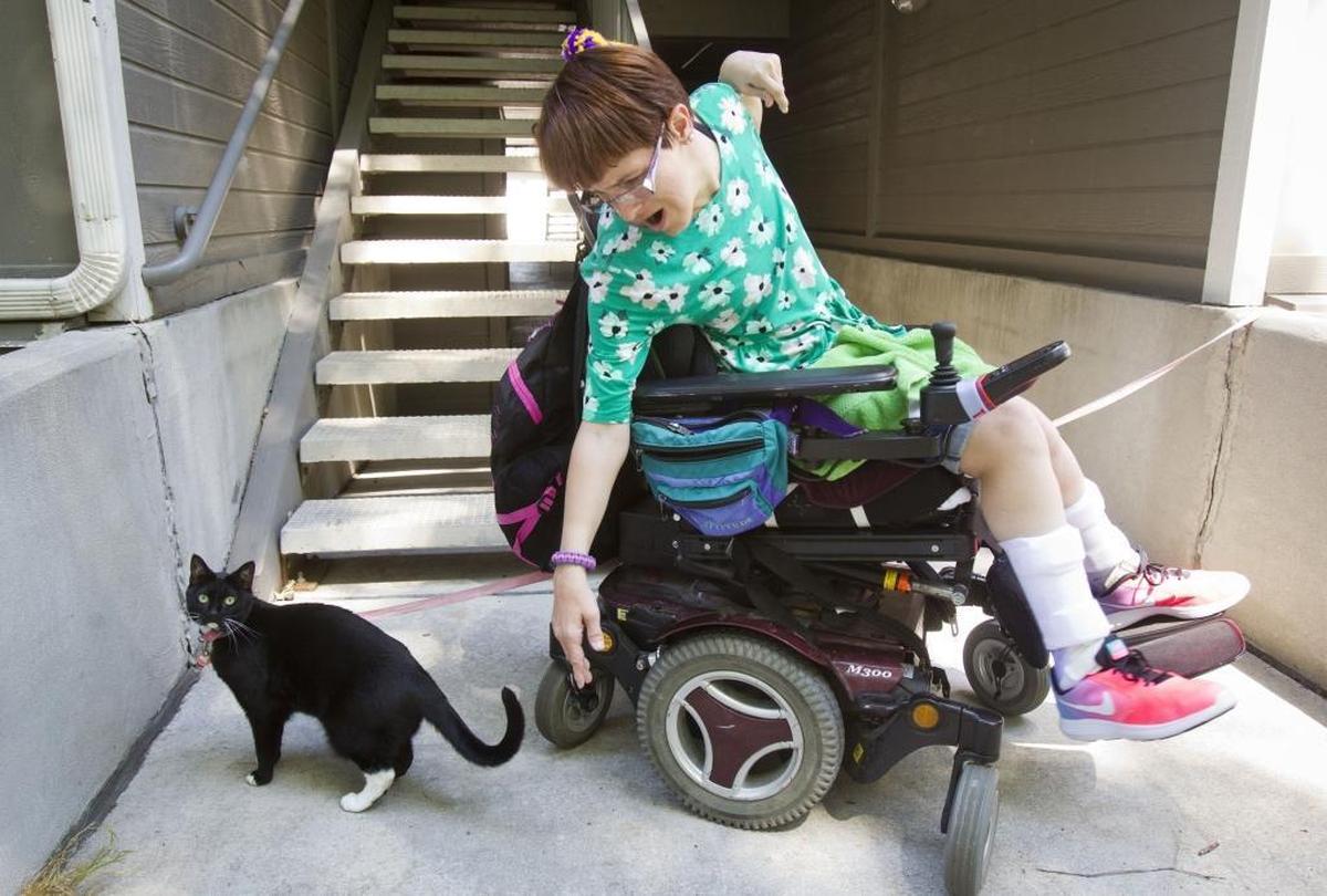 Kristyn Herbert, who has cerebral palsy, lives in her own apartment with a cat named Destiny, who she takes outside on a leash. Herbert is worried about what Medicaid cuts would do to her ability to live independently.