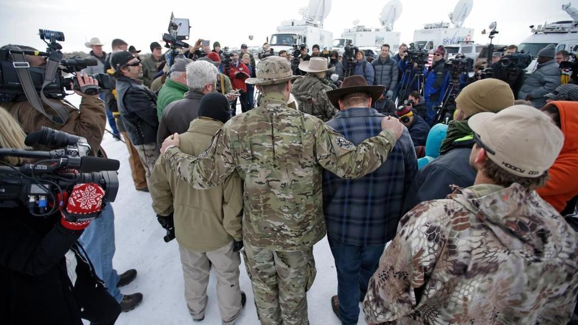 Members of the group occupying the Malheur National Wildlife Refuge headquarters hug after Ammon Bundy, center, left, one of the sons of Nevada rancher Cliven Bundy, spoke with reporters during a news conference Monday, Jan. 4, 2016, near Burns, Ore. The group calls itself Citizens for Constitutional Freedom and has sent a "demand for redress" to local, state and federal officials. Armed protesters took over the Malheur National Wildlife Refuge on Saturday after participating in a peaceful rally over the prison sentences of local ranchers Dwight and Steven Hammond.