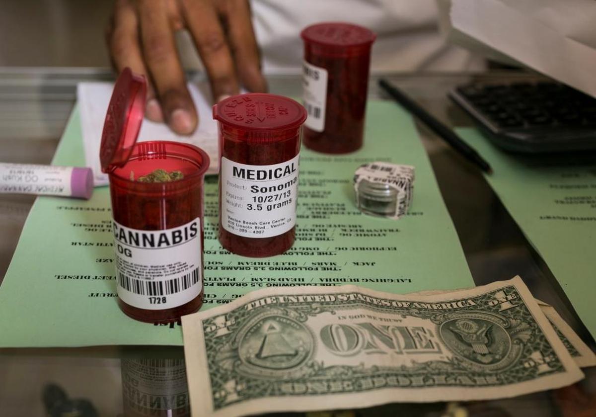 In this May 2013 photo, medical marijuana prescription vials are filled at a medical marijuana dispensary in Venice, Calif.