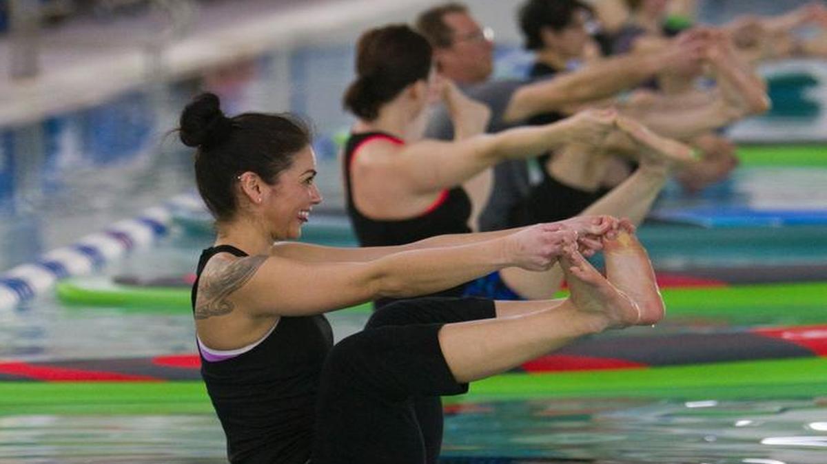 Participants in a paddleboard yoga class at the Treasure Valley West YMCA in February 2014.