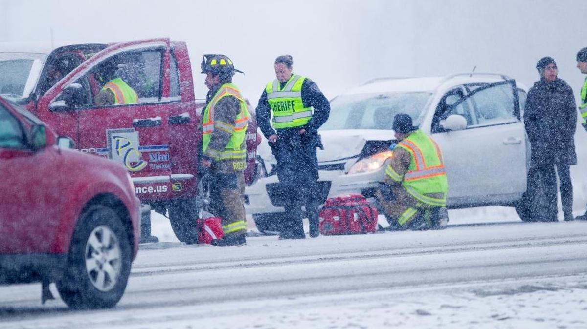 Eagle police and fire department workers respond to a minor crash on East State Street in Eagle about 10 a.m. Friday. Many crashes were reported throughout the Valley as drivers contended with snowfall, slick roads and holiday traffic.