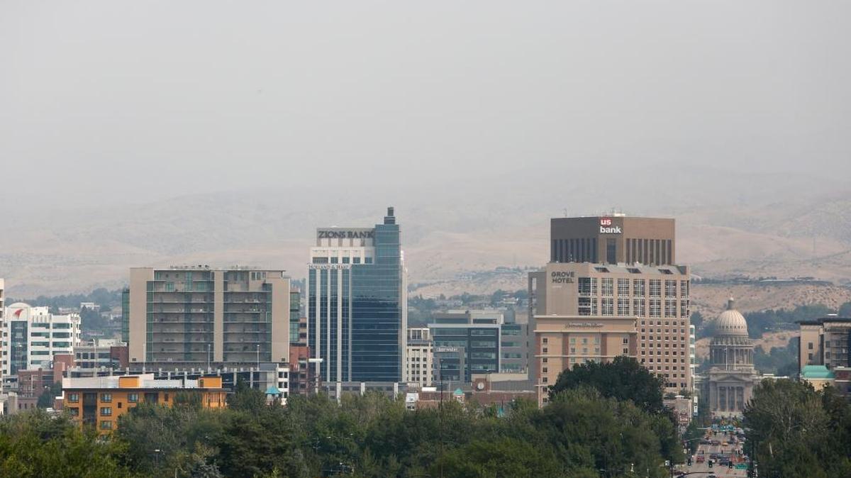 Smoke envelopes the foothills behind downtown Boise as photographed from the Boise Depot on Monday afternoon.
