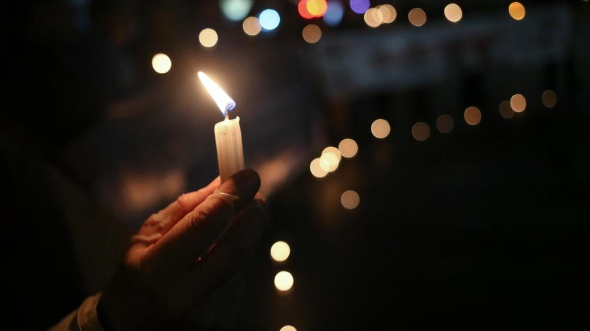 People light candles during a vigil for the victims of sexual abuse by priests outside the Cathedral in Santiago, Chile, Monday, Aug. 20, 2018.