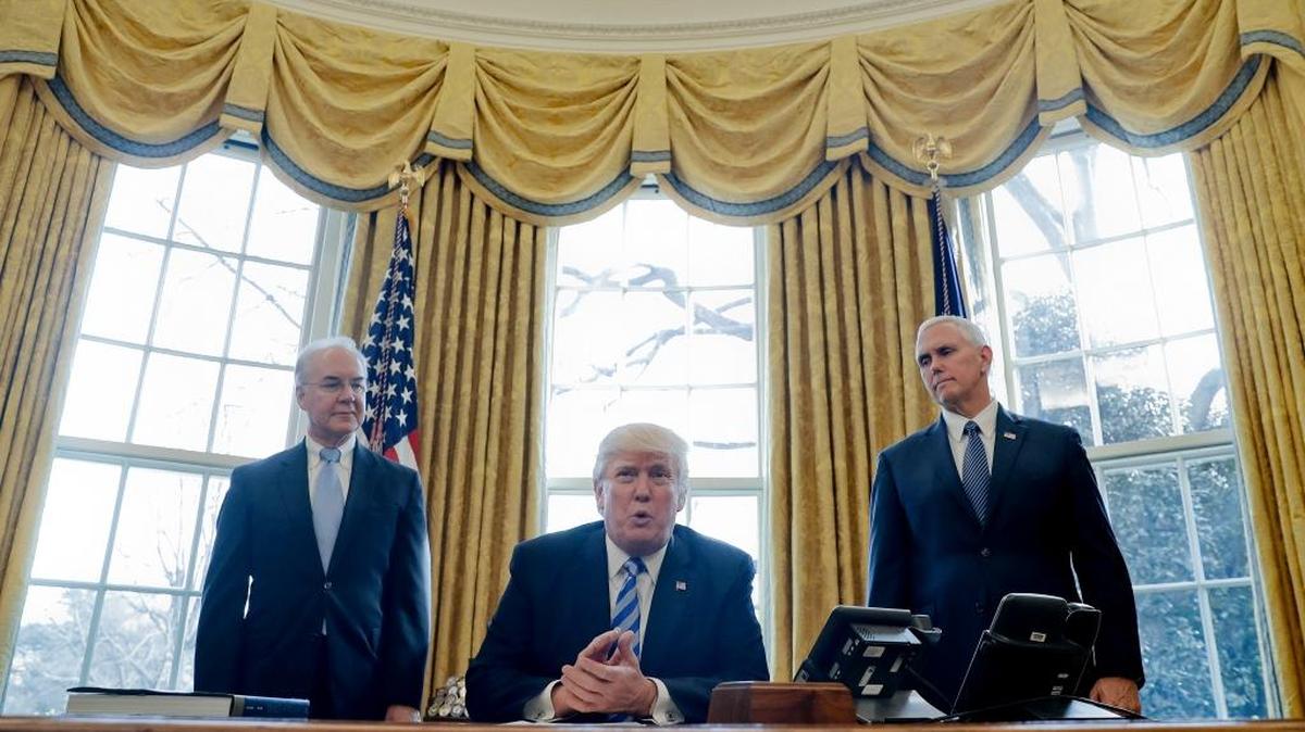 President Donald Trump, flanked by Health and Human Services Secretary Tom Price, left, and Vice President Mike Pence, speaks to members of the media regarding the health care overhaul bill, Friday, March 24, 2017, in the Oval Office of the White House in Washington. (AP)