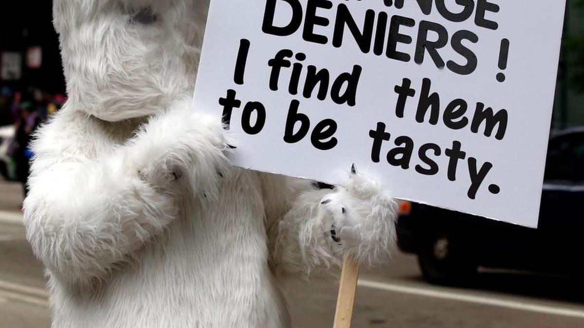 A demonstrator holds a sign during “100 Days of Failure” protest and march, Saturday, April 29, 2016, in Chicago. Thousands of people across the U.S. are marked President Donald Trump's hundredth day in office by marching in protest of his environmental policies. (AP)