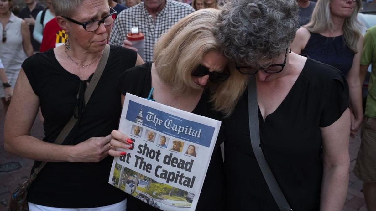 Andrea Chamblee, center, wife of shooting victim and reporter John McNamara, marches in the vigil held in downtown Annapolis, Md., on June 29. MUST CREDIT: Washington Post photo by Calla Kessler