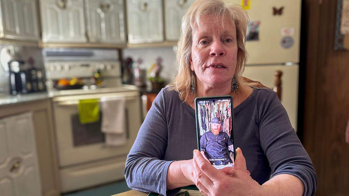 LuAnn Heston, of Melba, holds up a photo of her son, who is in an Idaho prison. Heston tries to live on about $900 a month, which is difficult when she’s charged exorbitant rates just to talk to her son by phone.