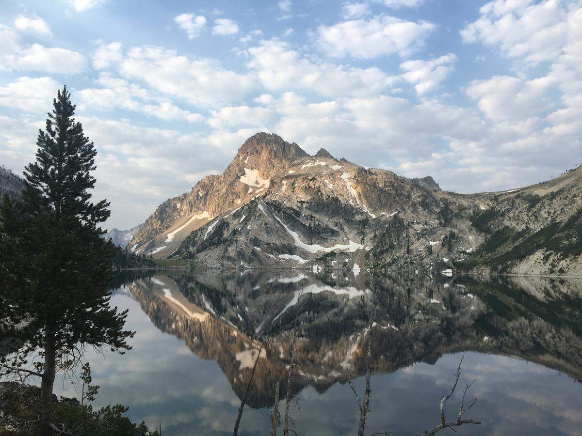 Nothing quite beats the feeling of waking up to a calm, quiet, high-mountain lake, like this scene at dawn on a trip in 2021 to Sawtooth Lake in the Sawtooth Wilderness in the Sawtooth National Recreation Area.