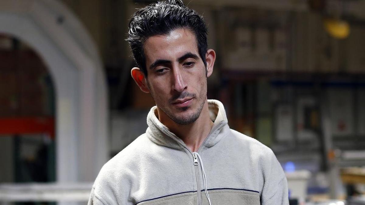 FILE - In this Nov. 16, 2015 file photo, Syria refugee Nedal Al-Hayk listens during an interview in Warren, Mich. Al-Hayk, who was resettled in suburban Detroit with his family after a three-year wait, said officials interviewed him and his wife in separate rooms, repeatedly asking detailed questions pressing them about their backgrounds and reasons for fleeing Syria. (AP)