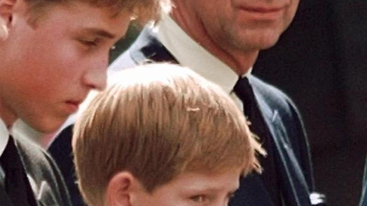 Britain's Prince Charlescasts a concerned glance towards his sons Prince William, left, and Prince Harry as they wait for the coffin of Princess Diana to be loaded into a hearse outside of Westminster Abbey in London in 1997.