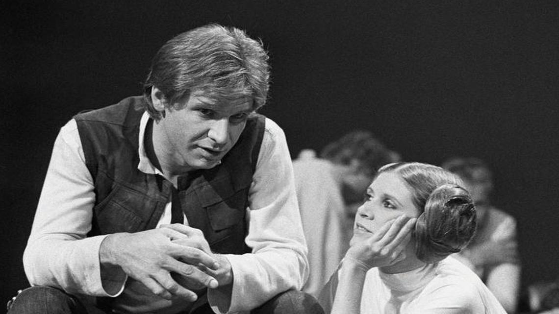 In this Nov. 13, 1978 photo, Harrison Ford talks with Carrie Fisher during a break in the filming of the CBS-TV special "The Star Wars Holiday" in Los Angeles.