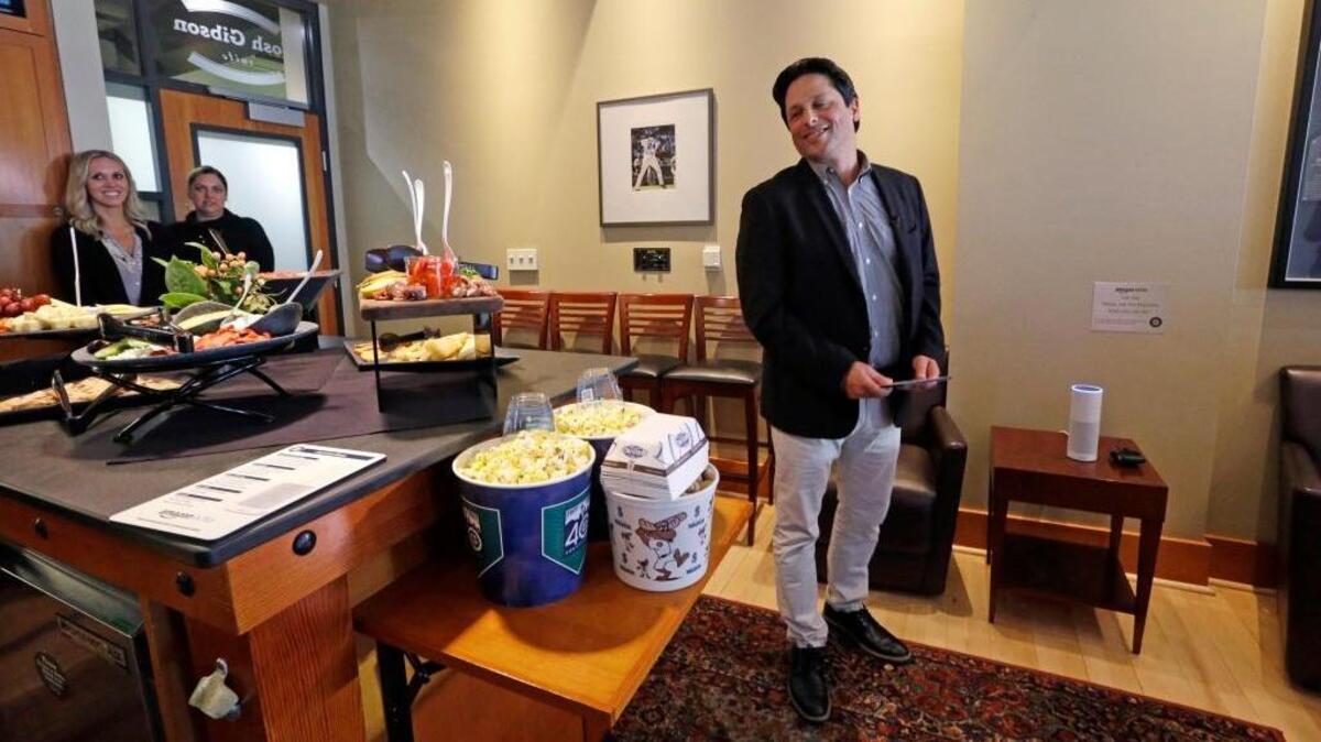David Curry, Seattle Mariners technology vice president, demonstrates an Amazon Alexa device in a suite before a game in Seattle. The Mariners have partnered with their hometown neighbors to create the first integration between pro sports and Alexa’s voice-activated platform.