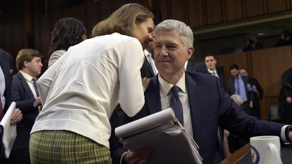 Marie Louise Gorsuch, wife of Supreme Court nominee Neil Gorsuch, talks to him during a break in testimony on Capitol Hill on Wednesday.
