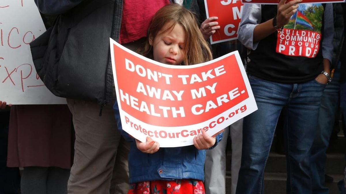 A Colorado girl demonstrates for health care in January.